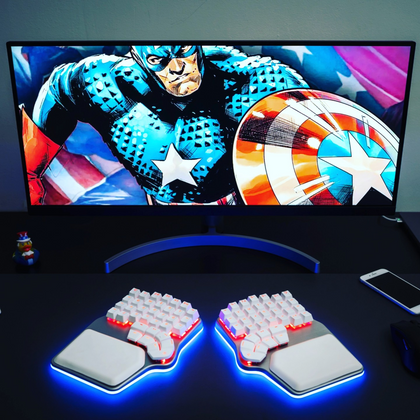 Silver Dygma Defy with white keycaps and red and blue RGB
